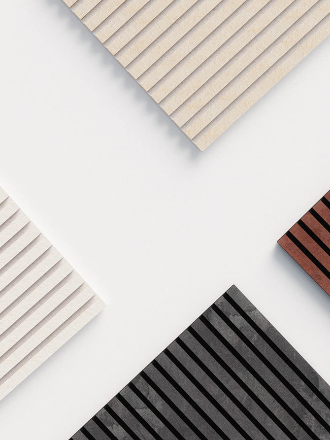 Various Akurock acoustic panels from stonearts® in the colors white, black, red and beige, with a modern lamella structure.