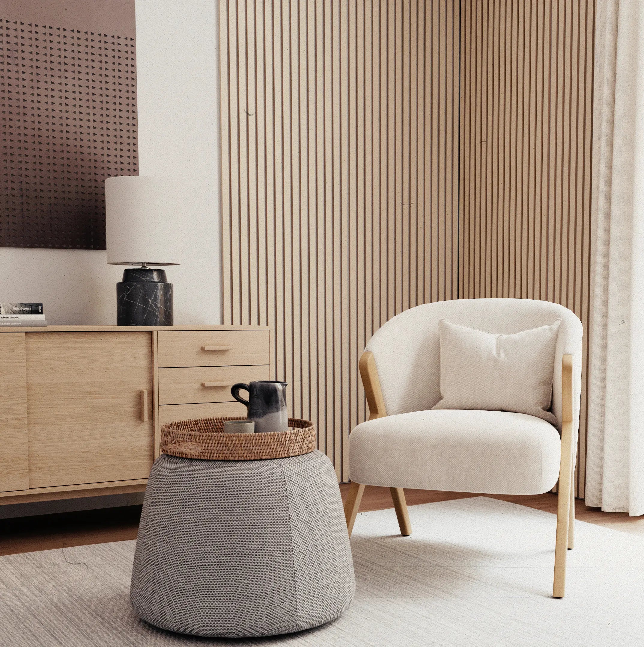 Scandinavian living room with light colors, a comfortable armchair and a round side table. In the background, modern stonearts® wall coverings that help to improve the room acoustics.