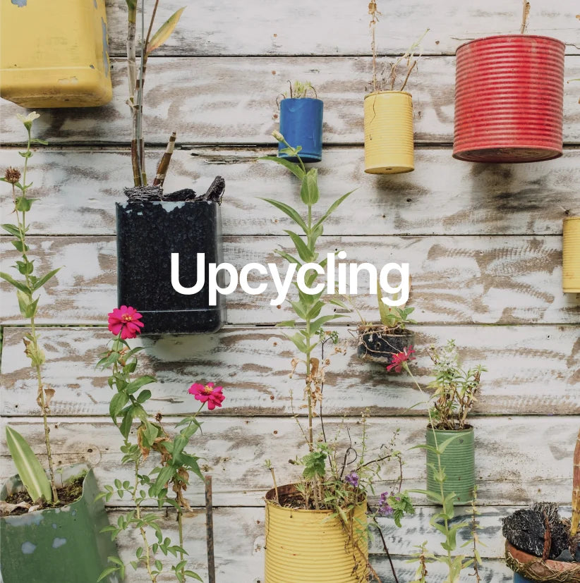 Colorful cans hung on a wall as planters symbolize the upcycling and sustainability of stonearts® products.